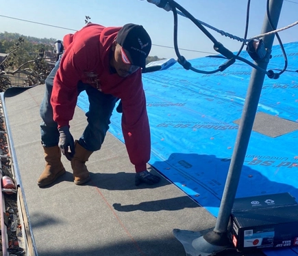 Johnson Restoration Worker on Roof
