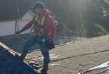 Johnson Restoration Worker on Roof