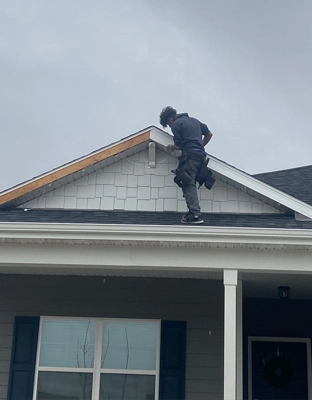 Johnson Restoration Worker Installing Shingles