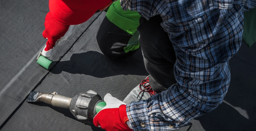 Johnson Restoration Worker Repairs EPDM Roof